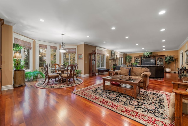 living room with wood-type flooring and ornamental molding