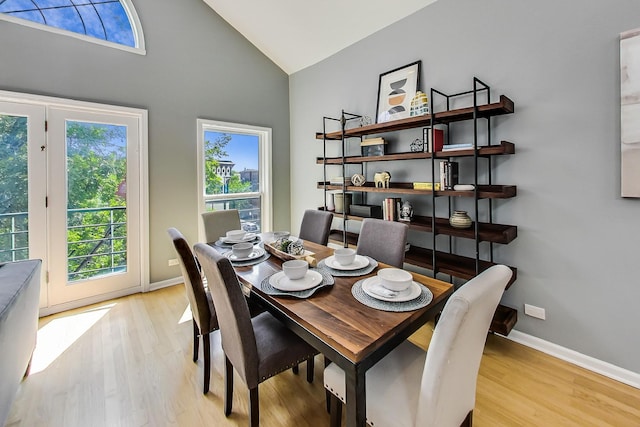 dining area with vaulted ceiling and light hardwood / wood-style floors