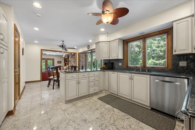 kitchen with sink, backsplash, kitchen peninsula, ceiling fan, and stainless steel dishwasher