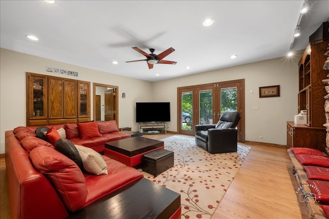 living room with light hardwood / wood-style floors and ceiling fan