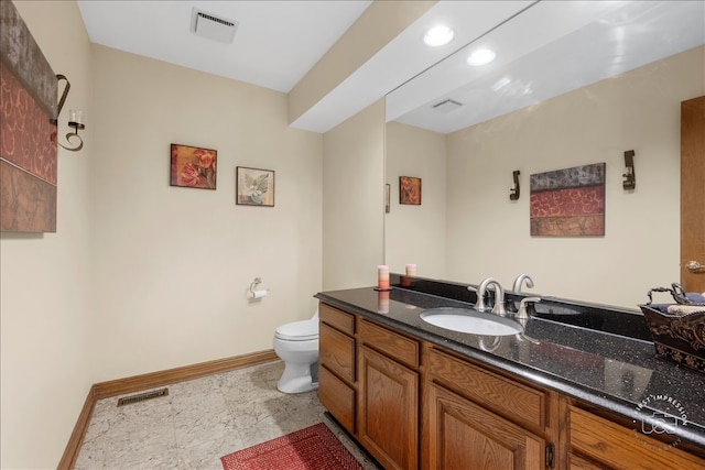 bathroom with toilet and vanity