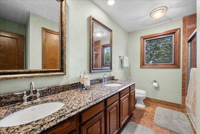 bathroom with vanity, toilet, walk in shower, and tile patterned flooring