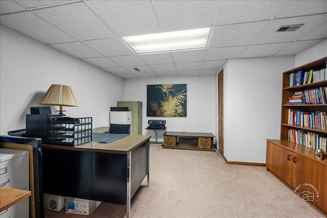 carpeted office space featuring a drop ceiling