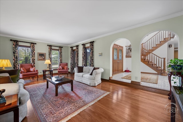 living room with ornamental molding and wood-type flooring