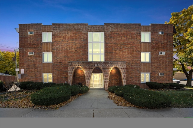 view of outdoor building at dusk