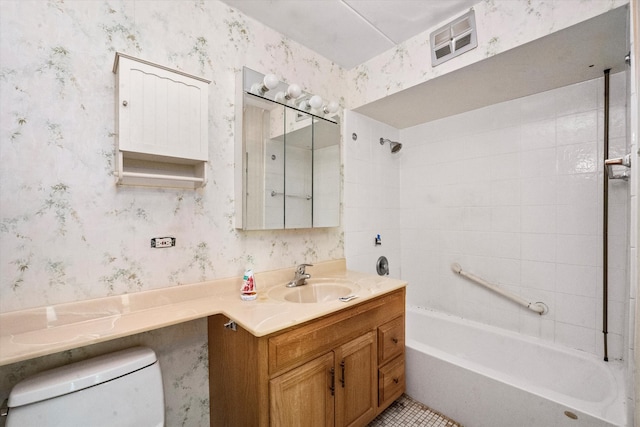 full bathroom with vanity, tiled shower / bath combo, and toilet