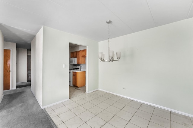 unfurnished dining area with a notable chandelier and light tile patterned flooring