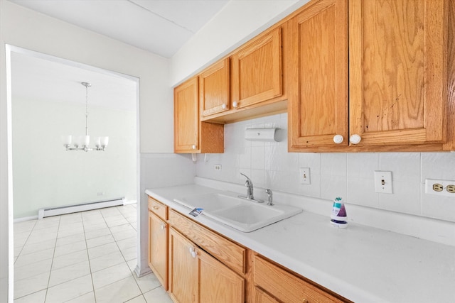 kitchen with sink, light tile patterned floors, a chandelier, a baseboard radiator, and decorative backsplash