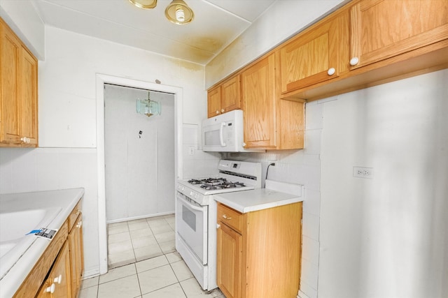 kitchen featuring backsplash, white appliances, and light tile patterned floors