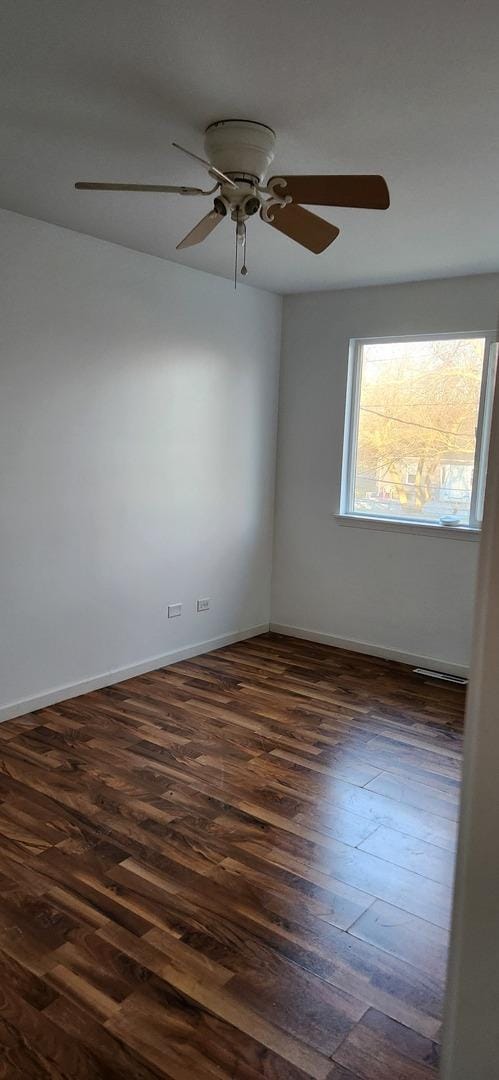 unfurnished room with dark hardwood / wood-style floors and ceiling fan