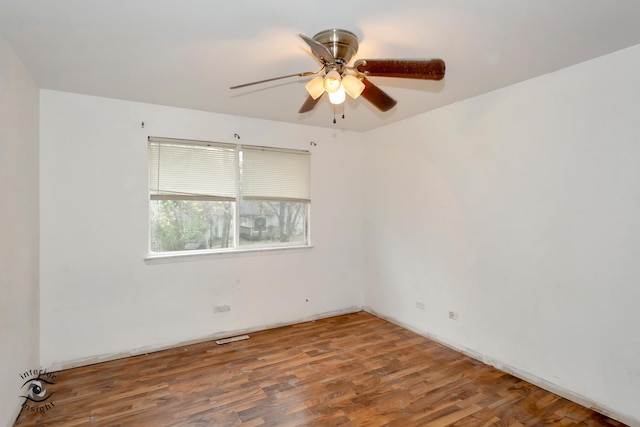 spare room with hardwood / wood-style floors and ceiling fan