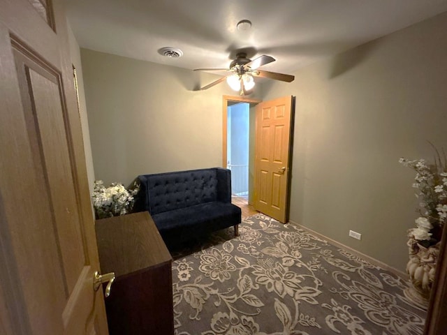 sitting room with carpet flooring and ceiling fan