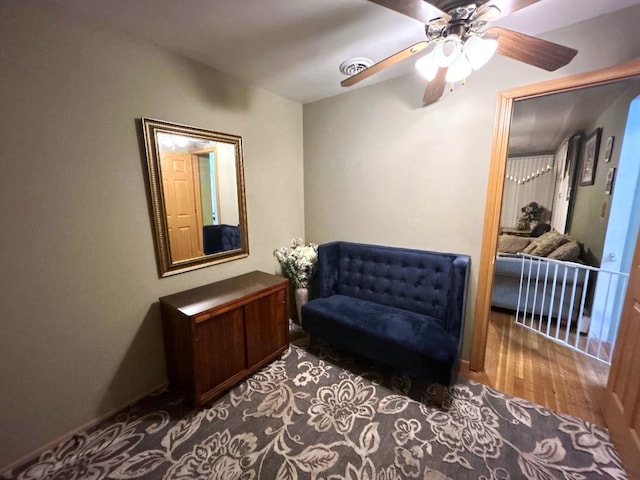 living area featuring ceiling fan and hardwood / wood-style flooring