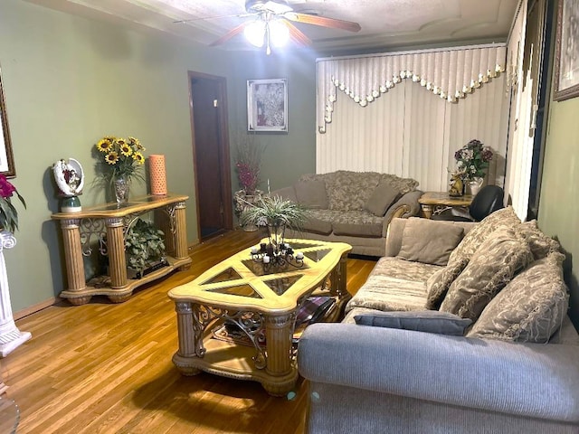 living room featuring hardwood / wood-style flooring and ceiling fan