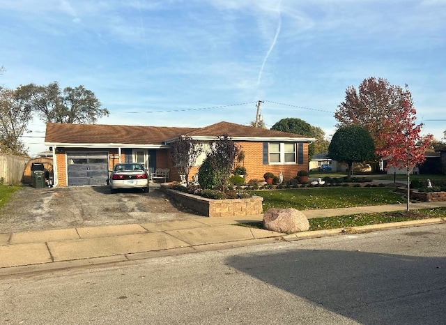 ranch-style home with a front yard and a garage