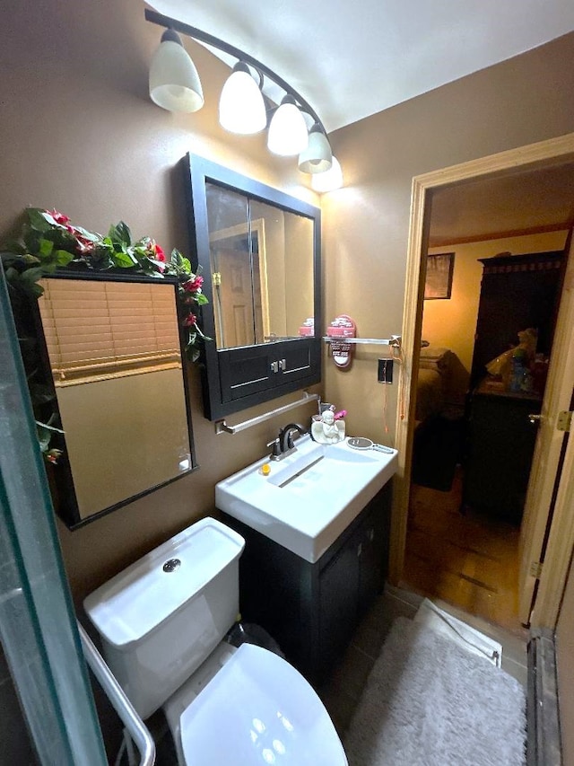 bathroom with vanity, toilet, and tile patterned flooring