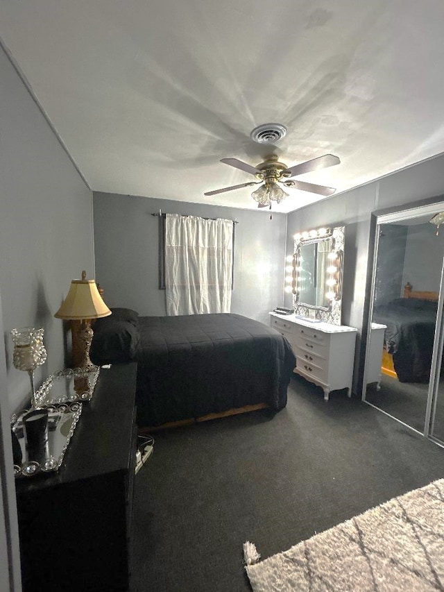 carpeted bedroom with a closet and ceiling fan