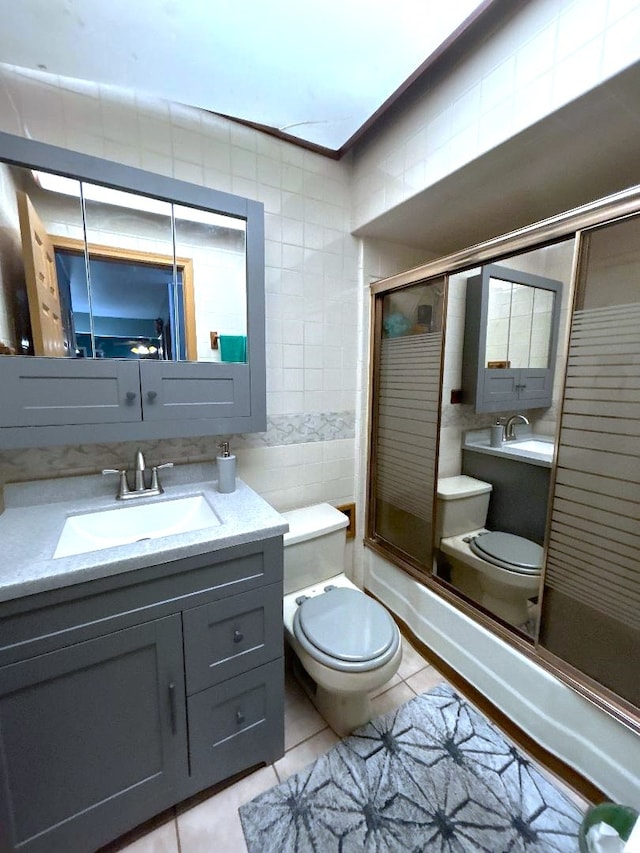 16409 Craig Dr, Oak Forest, IL 60452 - full bath featuring toilet, tile patterned flooring, vanity, combined bath / shower with glass door, and tile walls