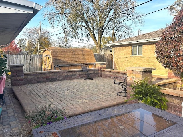 view of patio / terrace with a storage shed