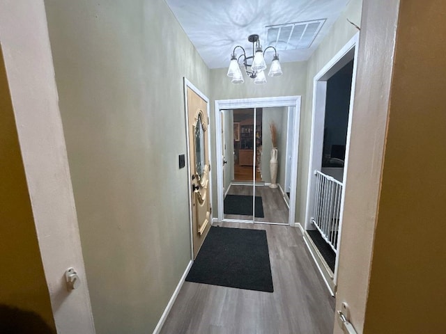 16409 Craig Dr, Oak Forest, IL 60452 - doorway to outside featuring a chandelier, wood finished floors, and baseboards