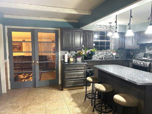 16409 Craig Dr, Oak Forest, IL 60452 - bar area with range, a sink, tasteful backsplash, ventilation hood, and light tile patterned floors