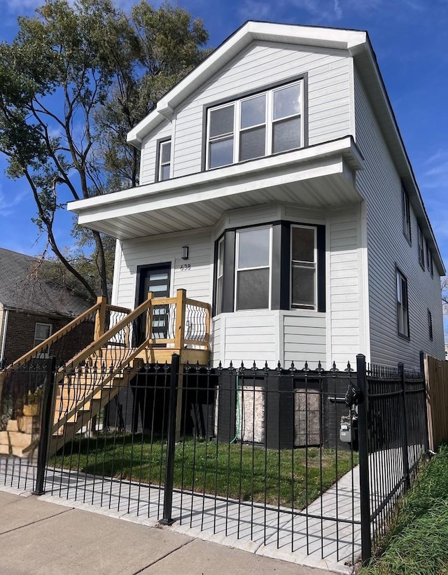 638 E 65th St, Chicago, IL 60637 - view of front of property with stairs, a fenced front yard, and a porch