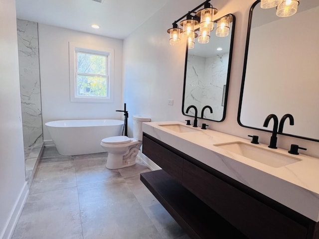 638 E 65th St, Chicago, IL 60637 - bathroom with a freestanding bath, double vanity, recessed lighting, toilet, and baseboards