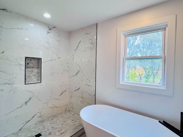 bathroom featuring a tub to relax in