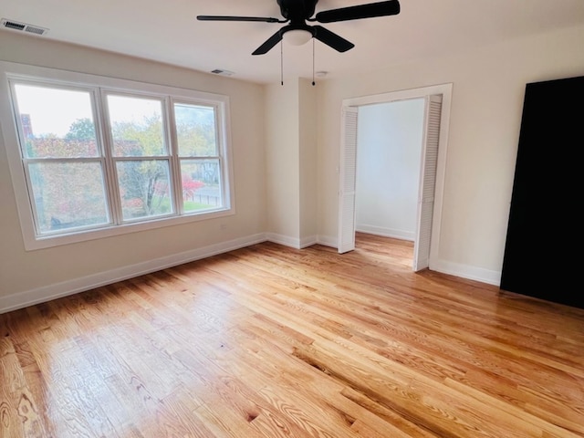 spare room featuring light hardwood / wood-style floors and ceiling fan