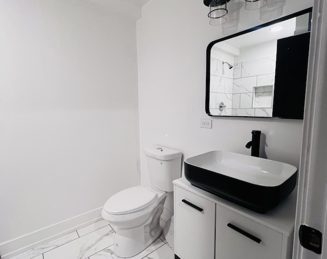 bathroom featuring a shower, vanity, and toilet