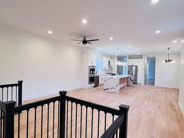 638 E 65th St, Chicago, IL 60637 - living room featuring light wood-type flooring, baseboards, ceiling fan, recessed lighting, and a chandelier