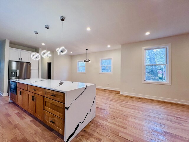 638 E 65th St, Chicago, IL 60637 - kitchen featuring light wood finished floors, baseboards, decorative light fixtures, and recessed lighting