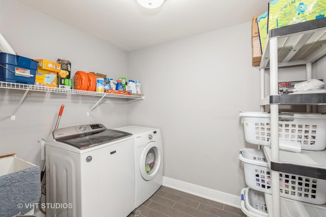 clothes washing area with separate washer and dryer and sink