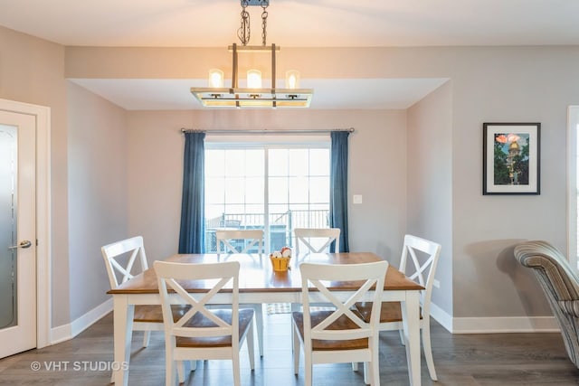 dining area with an inviting chandelier and wood-type flooring