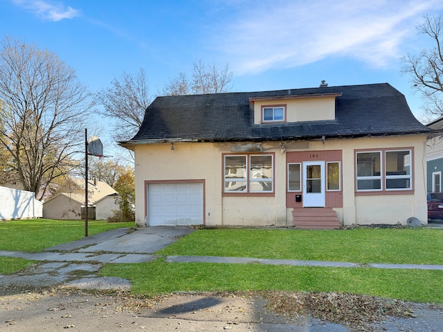 view of front of home with a garage and a front yard