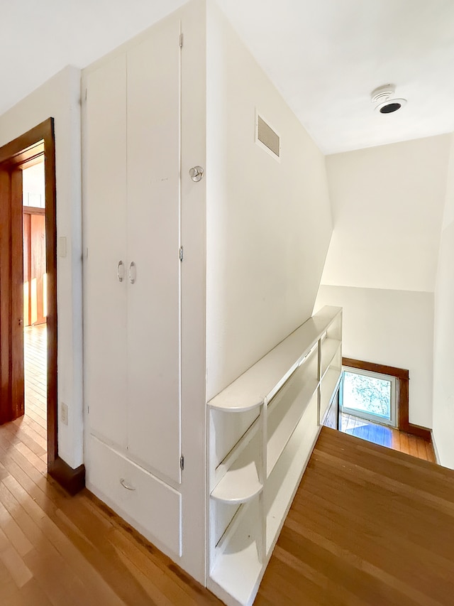 corridor with light hardwood / wood-style flooring