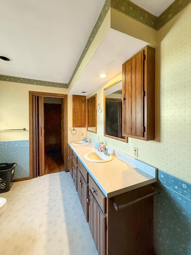 103 E Roosevelt St, Freeport, IL 61032 - full bath with wallpapered walls, double vanity, and toilet