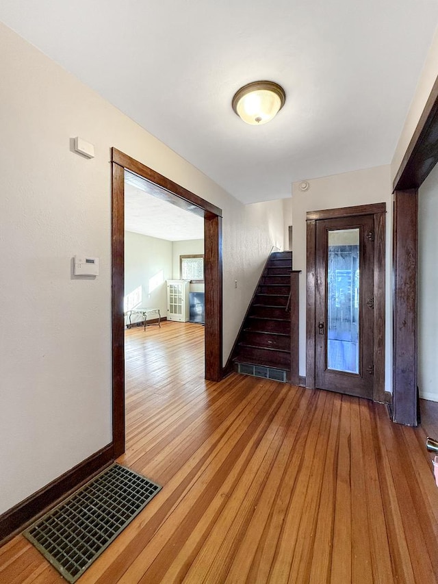 103 E Roosevelt St, Freeport, IL 61032 - entryway featuring stairs, light wood finished floors, and baseboards