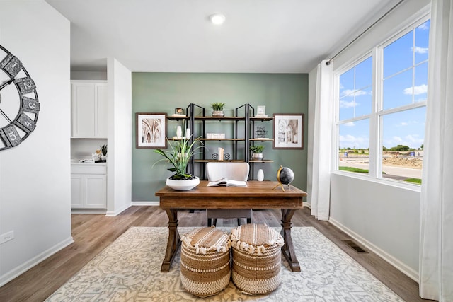 office with light hardwood / wood-style floors