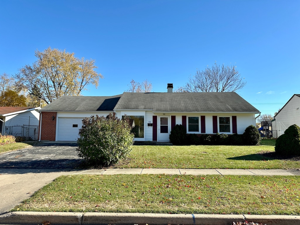 single story home with a front yard and a garage