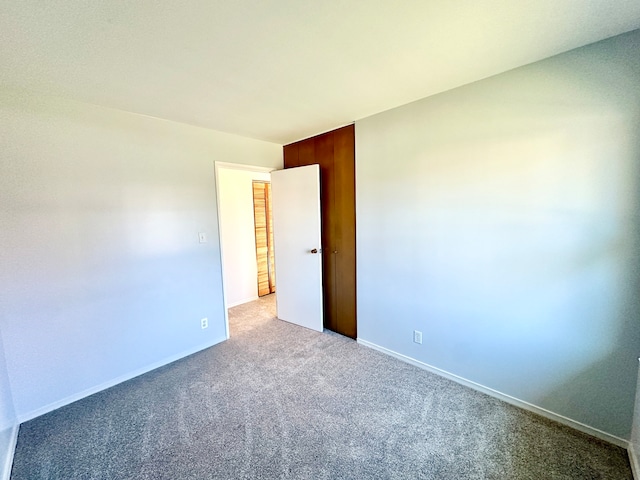 unfurnished room with light carpet