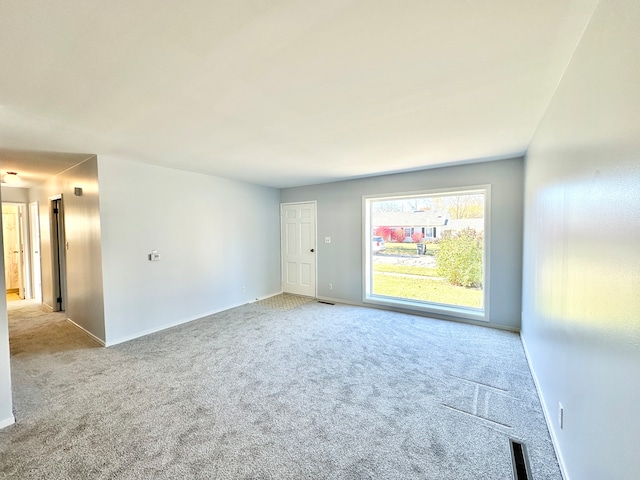 unfurnished room with light carpet