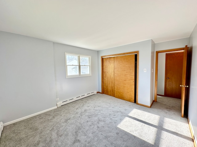 unfurnished bedroom featuring a closet, carpet flooring, and a baseboard radiator