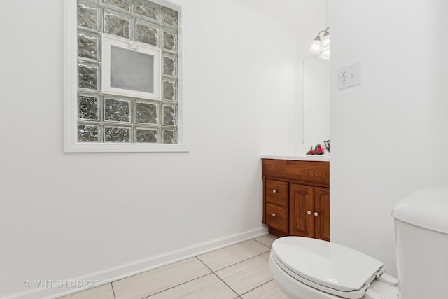 bathroom with tile patterned floors, vanity, and toilet