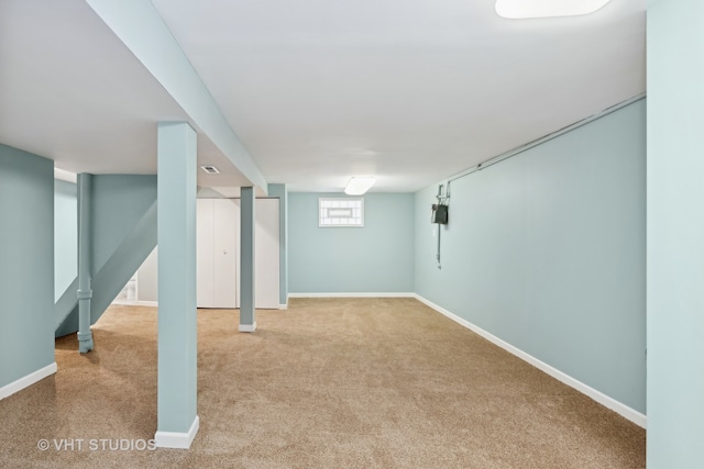 basement featuring light colored carpet