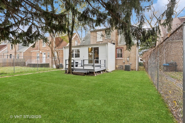 back of house featuring central air condition unit, a deck, and a lawn