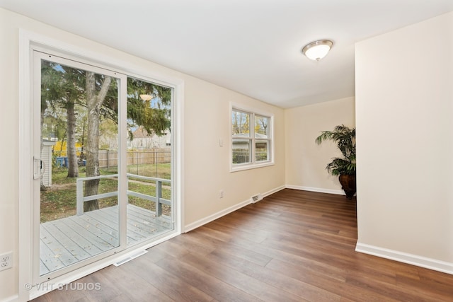 unfurnished room featuring dark wood-type flooring