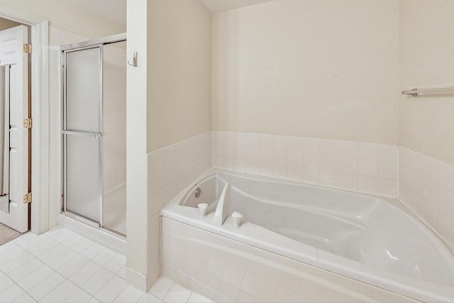 bathroom featuring tile patterned floors and independent shower and bath