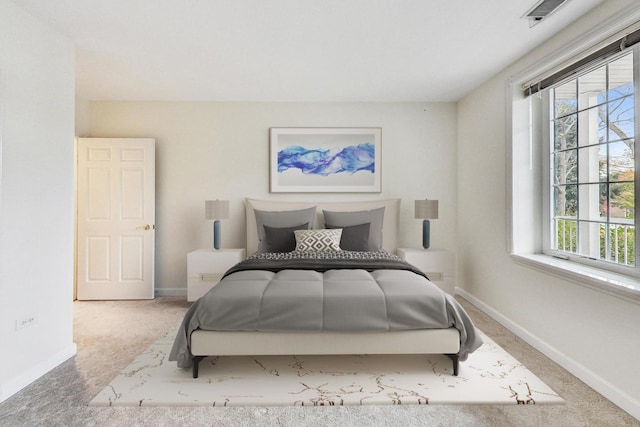 carpeted bedroom featuring multiple windows