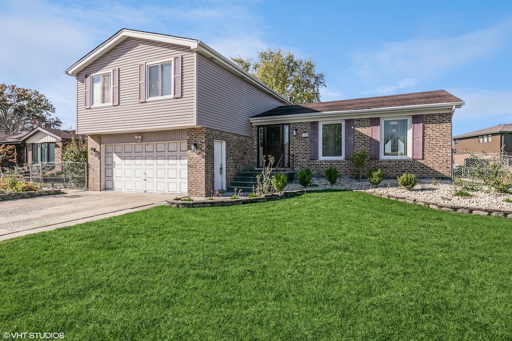 tri-level home with a front lawn and a garage